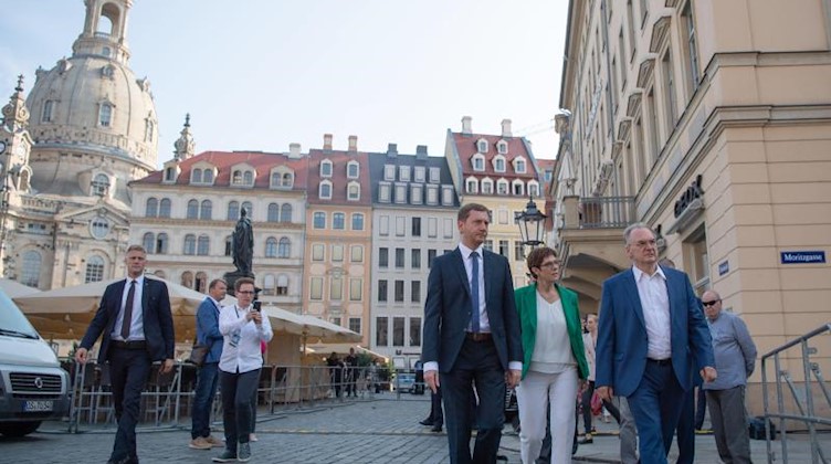 Michael Kretschmer (CDU, l.), Annegret Kramp-Karrenbauer, und Reiner Haseloff (CDU) laufen auf dem Neumarkt. Foto: Robert Michael/Archivbild