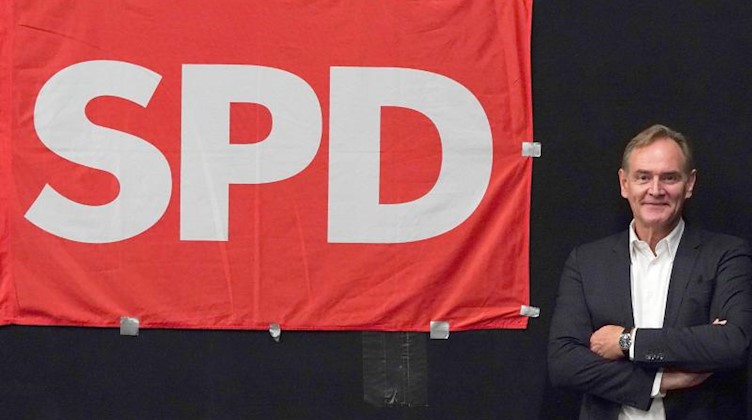 Burkhard Jung steht neben einer SPD-Flagge. Foto: Peter Endig