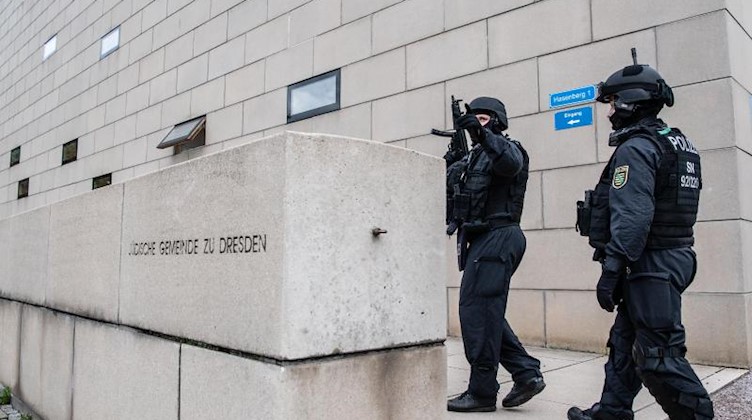 Polizisten stehen mit automatischen Waffen vor der Synagoge. Foto: Robert Michael/dpa-Zentralbild/dpa