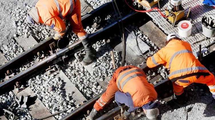 Ein Bautrupp der Bahn repariert ein Gleisbett. Foto: Roland Weihrauch/dpa
