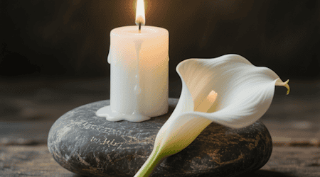 Im Gedenken an Verstorbene sind es die kleinen, stillen Symbole, wie Kerze, Stein, Blume und Licht, die Trost spenden. Symbolfoto