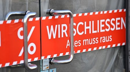 «Wir schliessen. Alles muss raus» steht auf dem Banner in der Tür eines Geschäfts in der Altstadt. / Foto: Martin Schutt/dpa-Zentralbild/dpa/Symbolbild