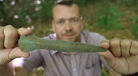 Maik Böhner hat einen Tausende Jahre alten Bronzedolch im Wald gefunden.  / Foto: Matthias Bein/dpa