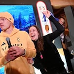 Rodler Max Langenhan steht mit seiner Freundin Susi auf der Bühne und singt das Thüringenlied mit seinen Fans. / Foto: Frank May/ picture alliance/Team D/dpa