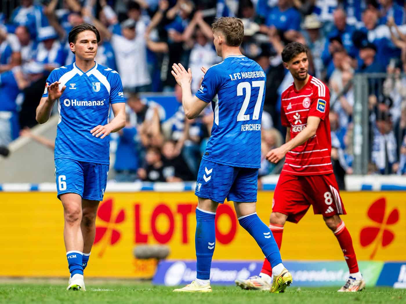 Magdeburgs Dariusz Stalmach (l) und Philipp Hercher klatschen nach dem Spiel ab / Foto: Julius Frick/dpa