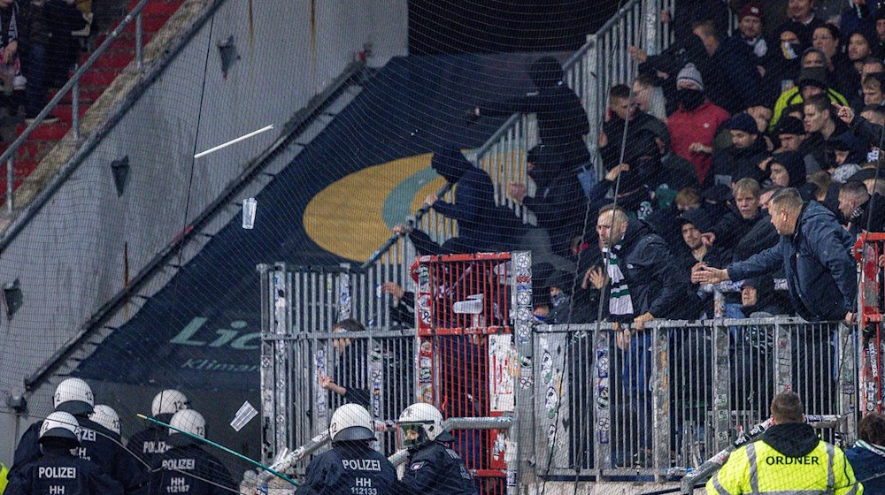 Gegenstände werden aus dem Fanblock der Hannoveraner auf Einsatzkräfte der Polizei geworfen. / Foto: Axel Heimken/dpa