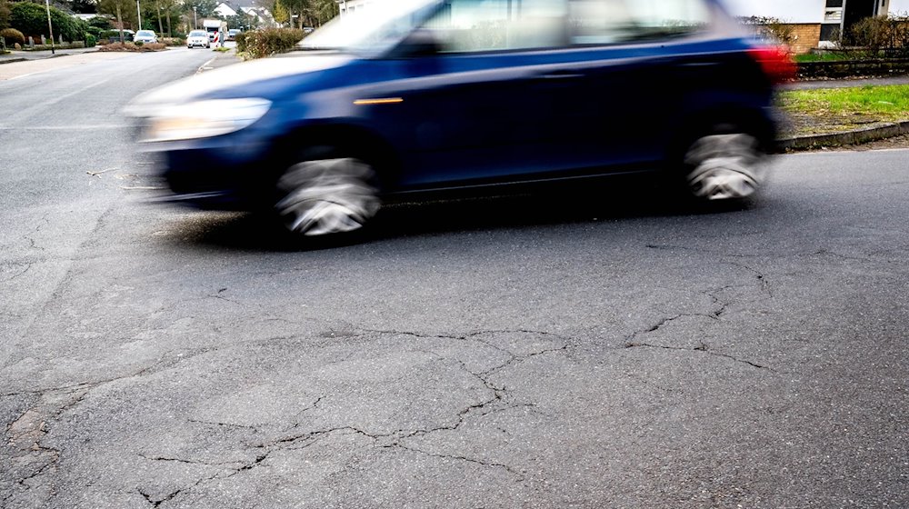 Risse im Asphalt einer Straßen in der Innenstadt von Verden. / Foto: Sina Schuldt/dpa