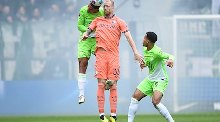 Wolfsburgs Maxence Lacroix (l) spielt gegen Bochums Philipp Hofmann. / Foto: Swen Pförtner/dpa