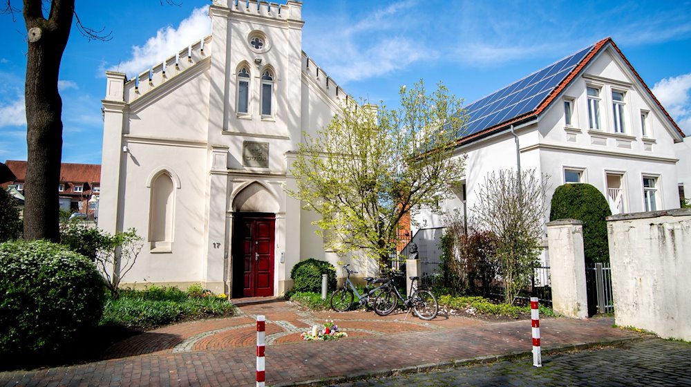 Zahlreiche Blumen und Kerzen liegen vor der Synagoge im Stadtzentrum. / Foto: Hauke-Christian Dittrich/dpa