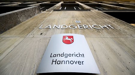 Ein Schriftzug und ein Schild hängen am Landgericht Hannover. / Foto: Julian Stratenschulte/dpa