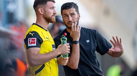 In der Gunst von BVB-Trainer Nuri Sahin (r.) steht Salih Özcan nicht weit oben. Das schürt Spekulationen über einen Wechsel nach Wolfsburg. / Foto: David Inderlied/dpa