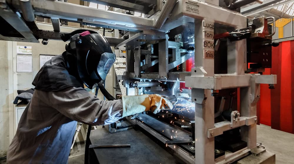 Eine Schweißerin während der Arbeit in Norderstedt (Schleswig-Holstein). / Foto: Markus Scholz/dpa