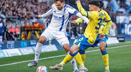 Die Braunschweiger Johan Gomez (verdeckt, Eintracht Braunschweig) und Robin Heußer bedrängen den Schalker Kenan Karaman (l). / Foto: Andreas Gora/dpa