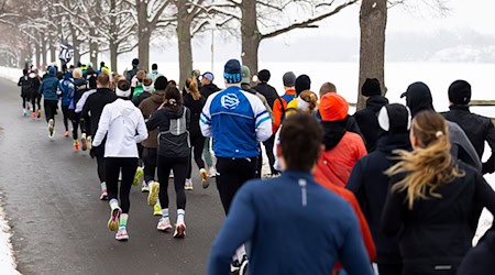 Sportfans laufen bei Winterwetter um den Maschsee in Hannover. / Foto: Michael Matthey/dpa
