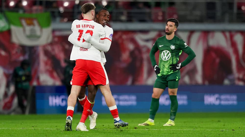 Wolfsburgs Stürmer Mohammed Amoura (r) sieht den Leipzigern beim Jubeln zu. / Foto: Jan Woitas/dpa