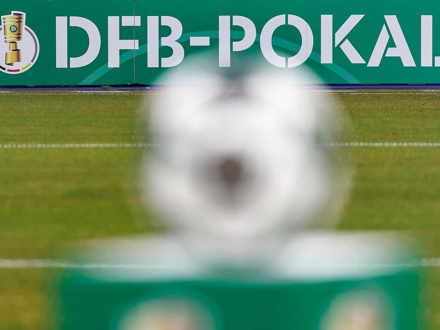 Eine Bande am Spielfeldrand zeigt den Schriftzug zum DFB-Pokal. (Archivbild) / Foto: Andreas Gora/dpa
