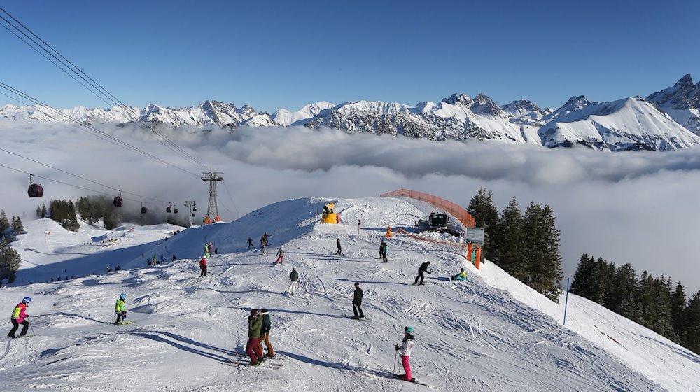 Wintersportler fahren auf dem Fellhorn über den Wolken im Sonnenschein. / Foto: Karl-Josef Hildenbrand/dpa/Archivbild