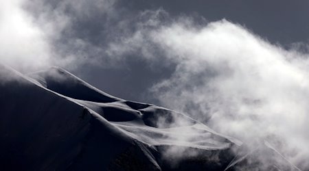 Wolken ziehen über die mit Neuschnee bedeckten Alpen. / Foto: Karl-Josef Hildenbrand/dpa