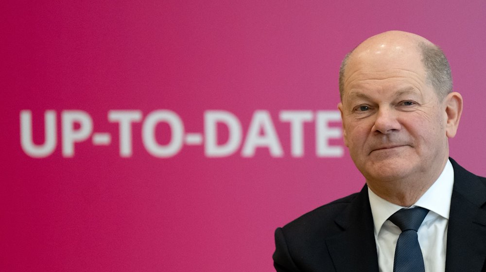 Bundeskanzler Olaf Scholz (SPD) nimmt nach dem Münchener Spitzengespräch der deutschen Wirtschaft an einem Gespräch mit jungen Handwerkern teil und sitzt dabei vor einer Wand mit der Aufschrift «Up-To-Date». / Foto: Sven Hoppe/dpa