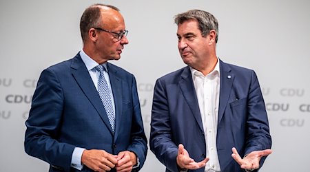 Markus Söder (CSU, r), Ministerpräsident von Bayern und CSU-Vorsitzender, spricht mit Friedrich Merz, CDU-Bundesvorsitzender, beim Bundesparteitag der CDU. / Foto: Michael Kappeler/dpa