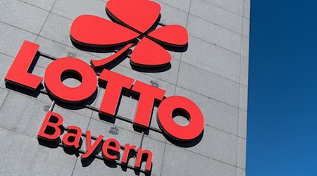 Das Logo und der Schriftzug "Lotto Bayern" sind an dem Firmengebäude der Lottozentrale zu sehen. / Foto: Sven Hoppe/dpa