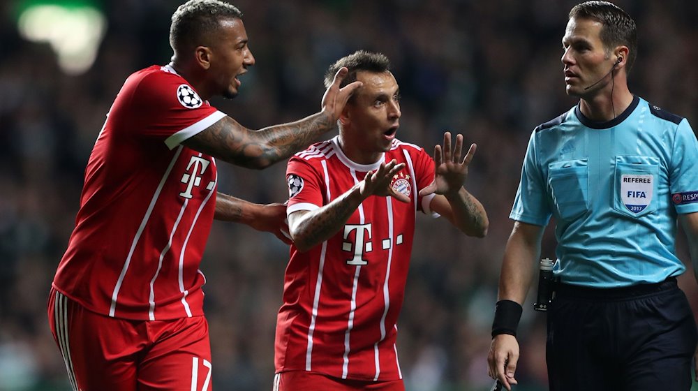 Die früheren Bayern-Profis Jerome Boateng (l-r) und Rafinha diskutieren mit Schiedsrichter Danny Makkelie. / Foto: Andrew Milligan/dpa/Archivbild