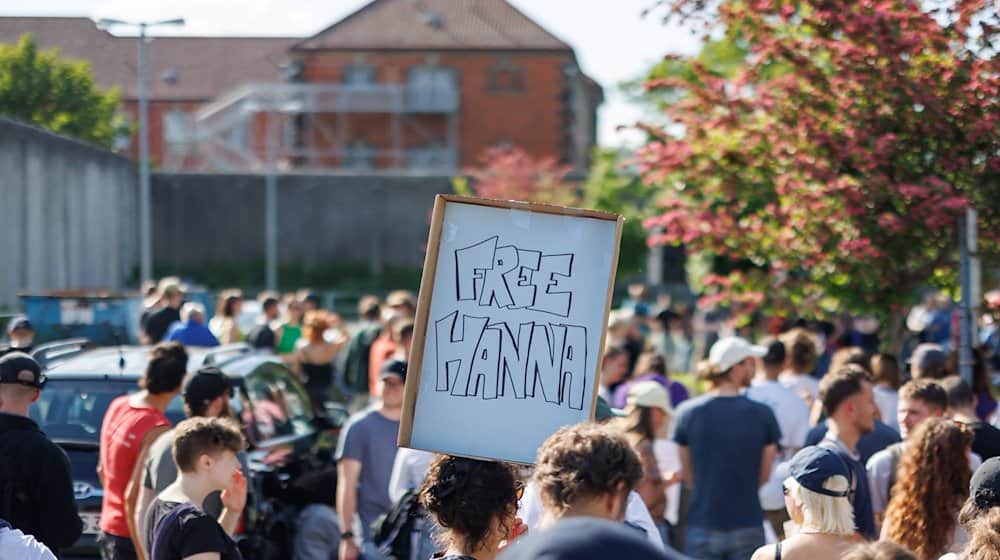 "Free Hanna" steht auf einem Schild einer Teilnehmerin einer Solidaritätskundgebung vor der Justizvollzugsanstalt für eine festgenommene mutmaßliche Linksextremistin. / Foto: Daniel Karmann/dpa