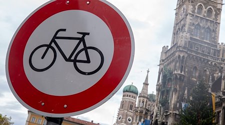Ein «Radfahren verboten»-Verkehrsschild ist in der Innenstadt vor der Kulisse der Frauenkirche und des Rathauses zu sehen. / Foto: Peter Kneffel/dpa