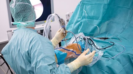 Ein Arzt operiert einen Patienten am Knie. / Foto: Sven Hoppe/dpa