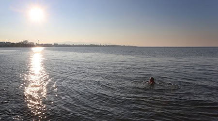 Eine Frau schwimmt nahe der deutschen Grenze im rund zehn Grad kalten Wasser des Bodensee. / Foto: Karl-Josef Hildenbrand/dpa