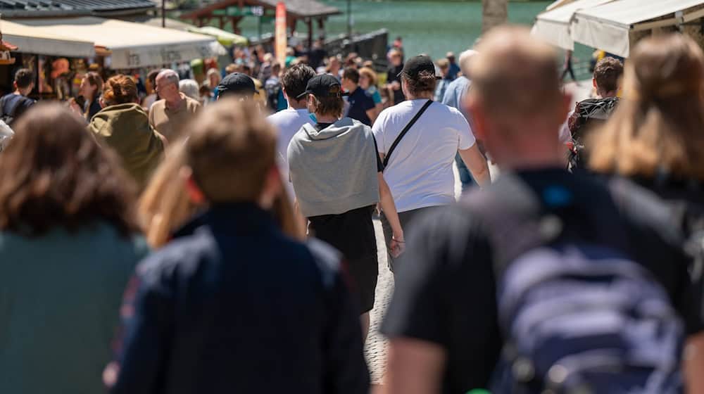 Touristen laufen eine Strasse zum Königssee hinunter. (Archivbild) / Foto: Peter Kneffel/dpa