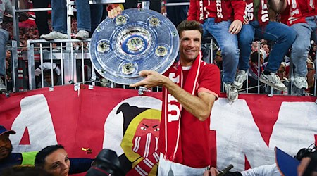 Thomas Müller zeigt die Meisterschale. / Foto: Tom Weller/dpa