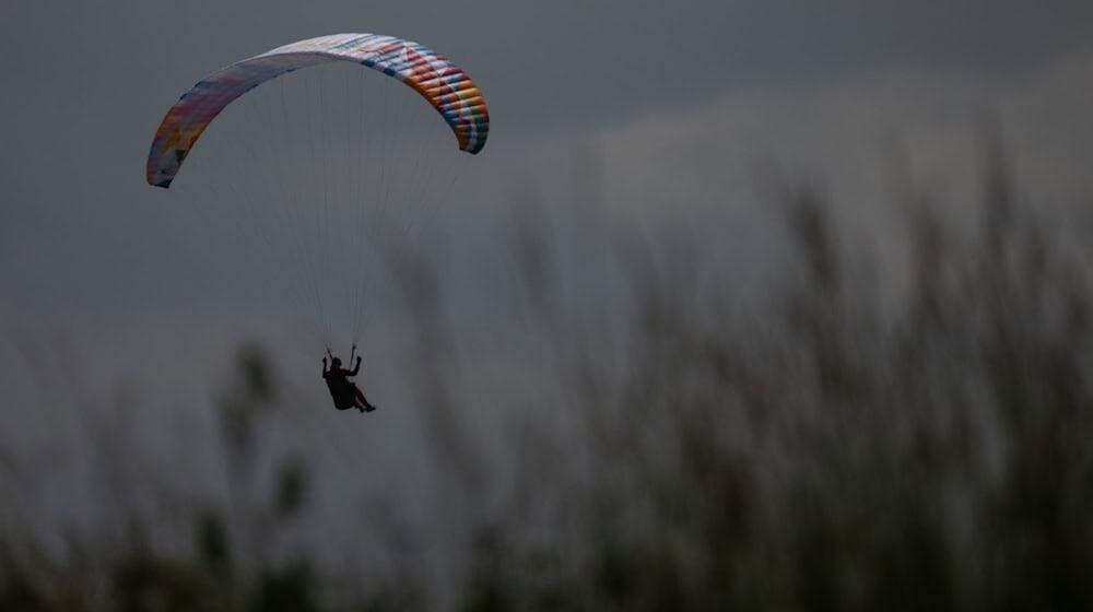 Kam es zu einem Gleitschirmunfall? Nach dem Anruf rücken sofort zahlreiche Kräfte aus. (Symbolbild) / Foto: Sebastian Gollnow/dpa