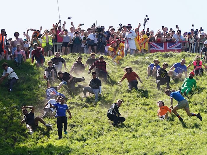 Das Käserennen in England hat Tradition.  / Foto: Jacob King/PA Wire/dpa