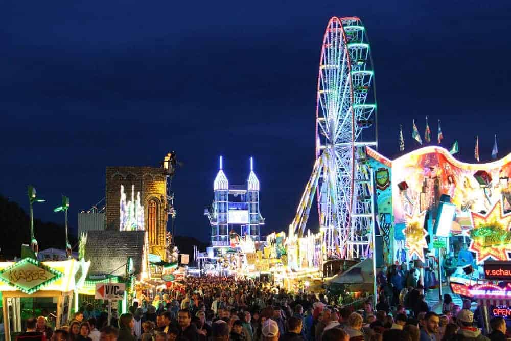 Das Altstadtfest in Rudolstadt in der Abenddämmerung mit Riesenrad und vielen Besuchern.