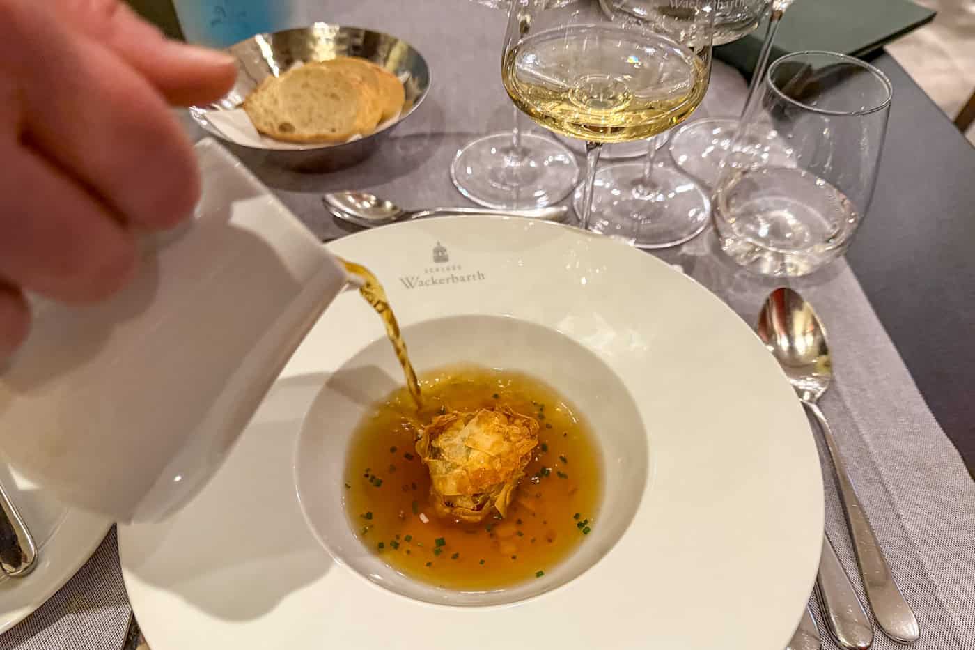 Teil des Kochsternstunden-Menüs: Wildconsommé mit Reh-Knusper-Praline. Foto: Ulrich van Stipriaan