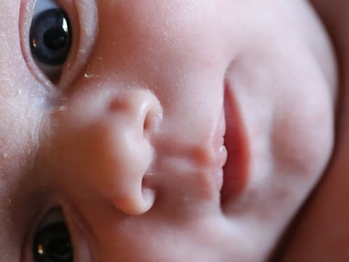 Close-up of a baby's face with its eyes open