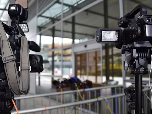 Two TV cameras at a press event