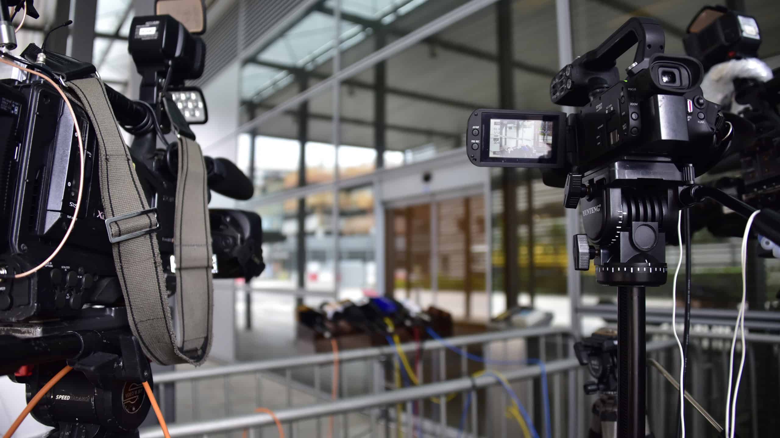 Two TV cameras at a press event
