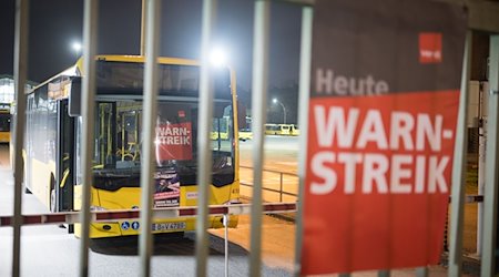 Ein Schild mit der Aufschrift «Warnstreik» hängt an einem Busdepot der BVG in der Müllerstraße. / Foto: Sebastian Gollnow/dpa