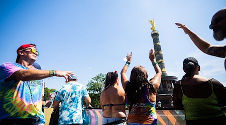 Menschen feiern bei der Technoparade «Rave the Planet» vor der Siegessäule auf einem Wagen. / Foto: Christoph Soeder/dpa/Archivbild