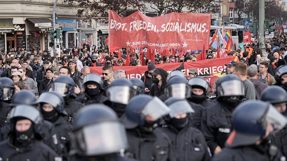 Ein Demonstrationszug zieht unter Polizeibegleitung mit Transparenten durch die Stadt. / Foto: Michael Kappeler/dpa/Archivbild