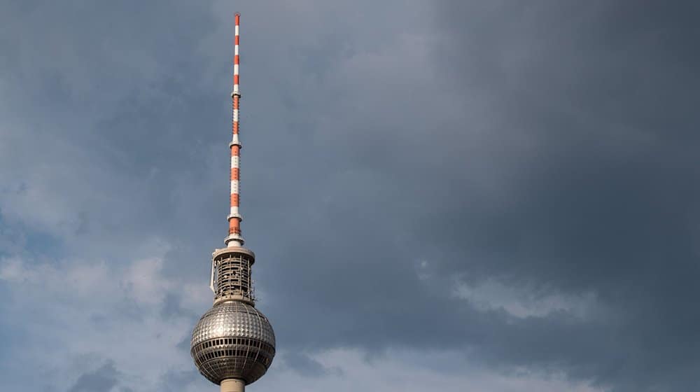 Hinter dem Berliner Fernsehturm ziehen dunkle Wolken auf. / Foto: Fabian Sommer/dpa
