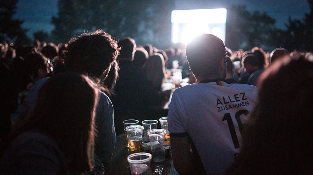 Fans verfolgen am 07.07.2016 auf der Fanmeile auf dem Tempelhofer Feld in Berlin das Spiel der deutschen Fussball-Nationalmannschaft im Halbfinalspiel der Fussball-Europameisterschaft 2016 gegen den Gastgeber Frankreich. / Foto: Sophia Kembowski/dpa