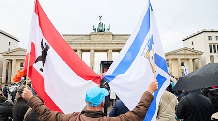 Rund 200 Menschen kommen vor dem Brandenburger Tor zusammen. / Foto: Annette Riedl/dpa