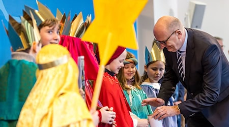 Die Sternsinger brachten am Eingang der Brandenburgischen Staatskanzlei einen Aufkleber mit dem Segen «Christus mansionem benedicat» (Christus segne dieses Haus) an.  / Foto: Frank Hammerschmidt/dpa