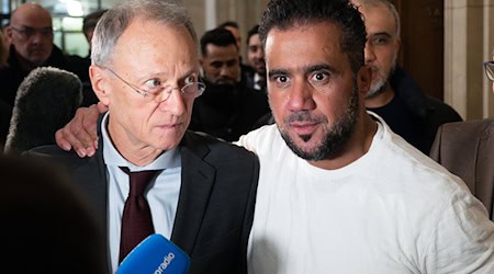 Buhsidos E-Manager Arafat Abou-Chaker (r) legt nach der Urteilsverkündung seinem Anwalt Hansgeorg Birkhoff die Hand auf die Schulter. (Archivbild)  / Foto: Sebastian Christoph Gollnow/dpa