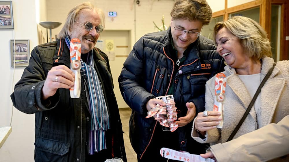 Musiker Frank Zander und sein Sohn Marcus sowie Petra Biernoth bei der Übergabe von gestifteten Zahnbürsten in der Notübernachtung der Berliner Kältehilfe der Caritas. / Foto: Britta Pedersen/dpa