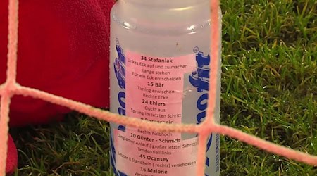 Trinkflasche mit Elfmeter-Zettel von Marius Funk. / Foto: -/MagentaSport/dpa