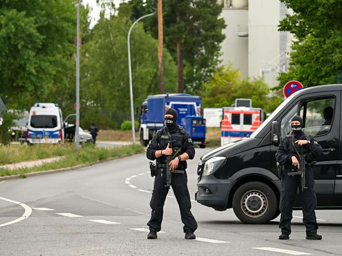 Schwer bewaffnete Polizisten sperren den Zugang zu einer Halle in Ludwigsfelde ab, wo es Durchsuchungen gibt. / Foto: Soeren Stache/dpa
